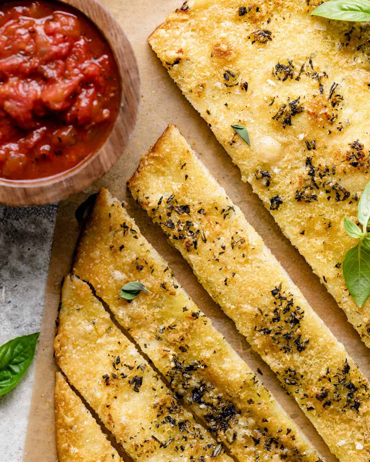 Up close photo of garlic herb breadsticks.