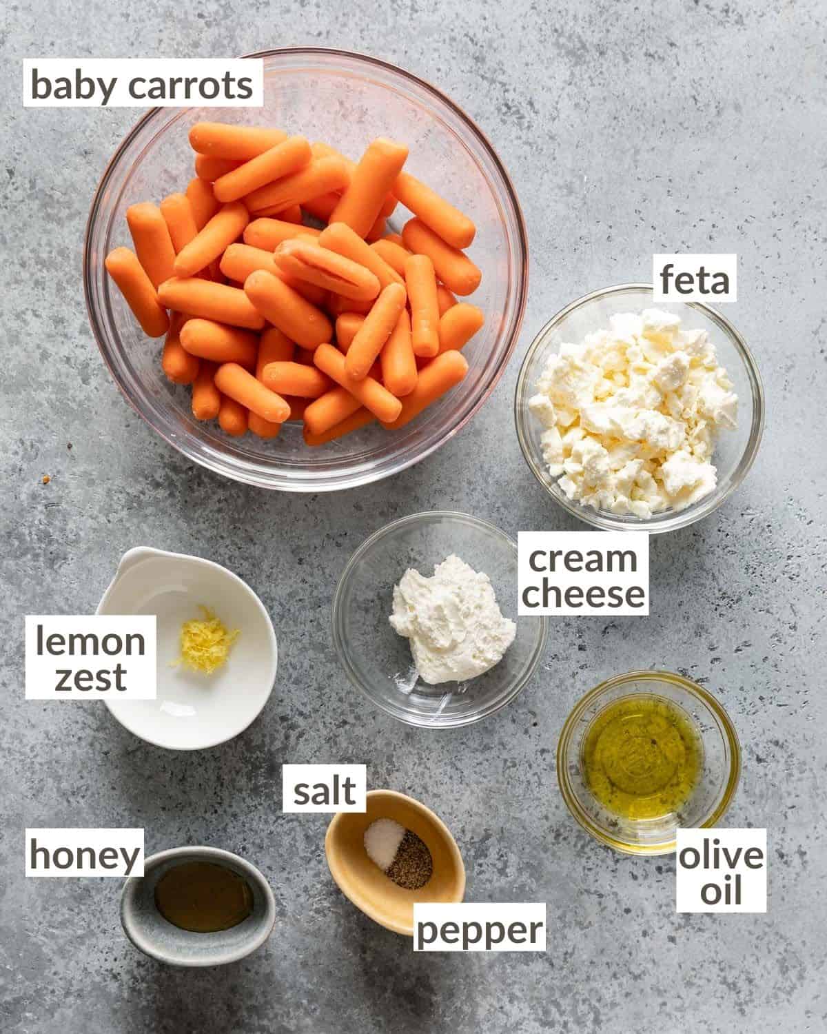 overhead of ingredients in bowls for air fryer baby carrots