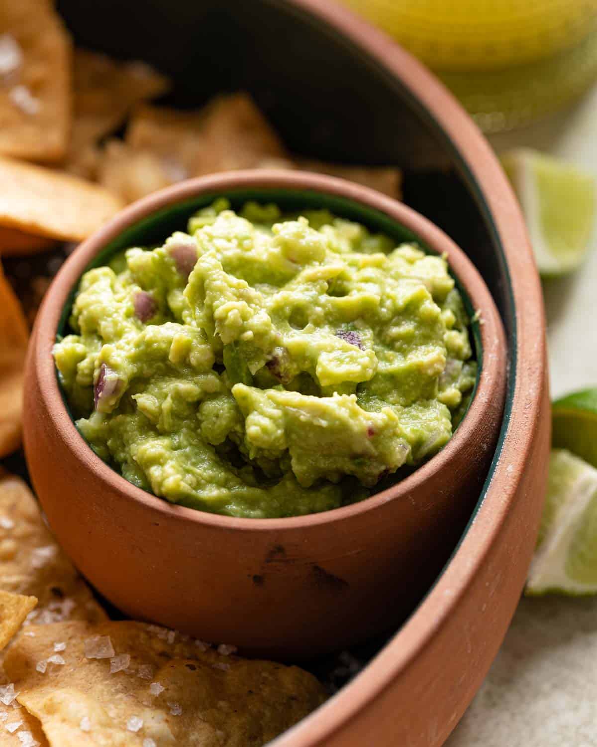 side shot of 4 ingredient guacamole with chips on the side