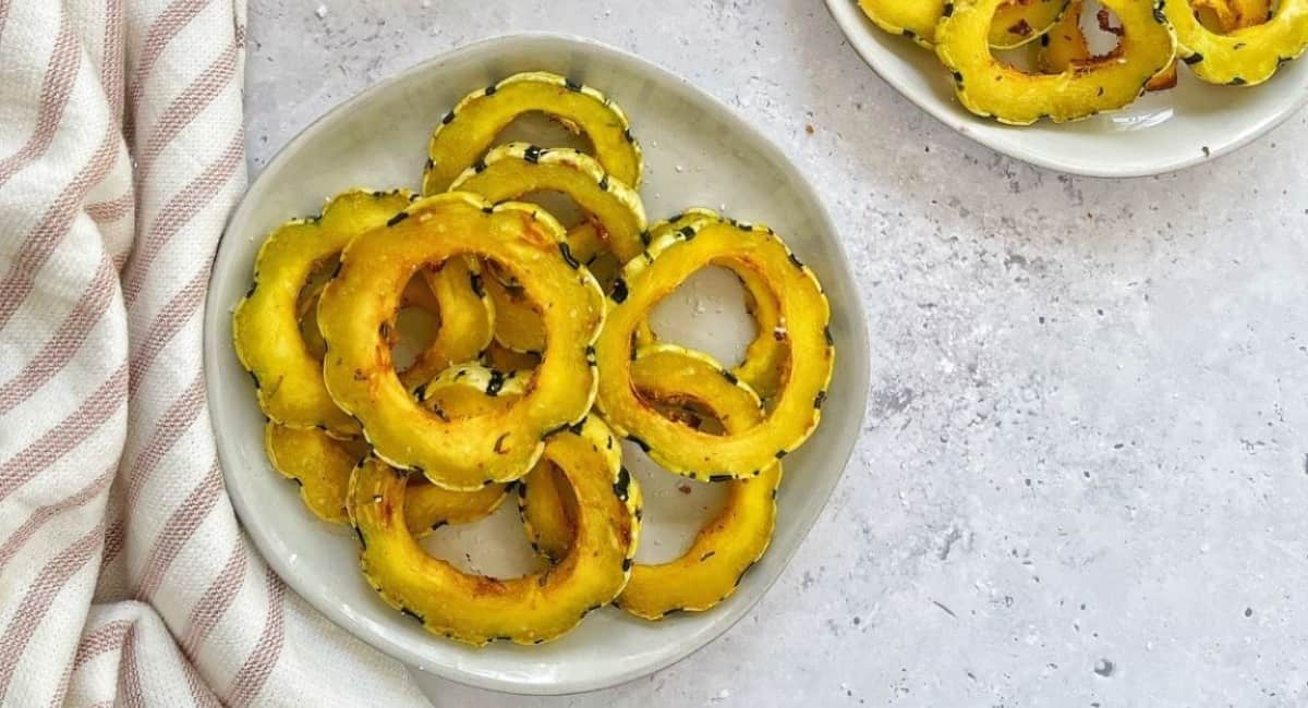 Air fried delicata squash served on a white plate.