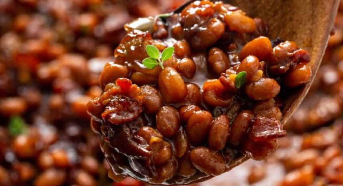 Baked beans on a wooden spoon.