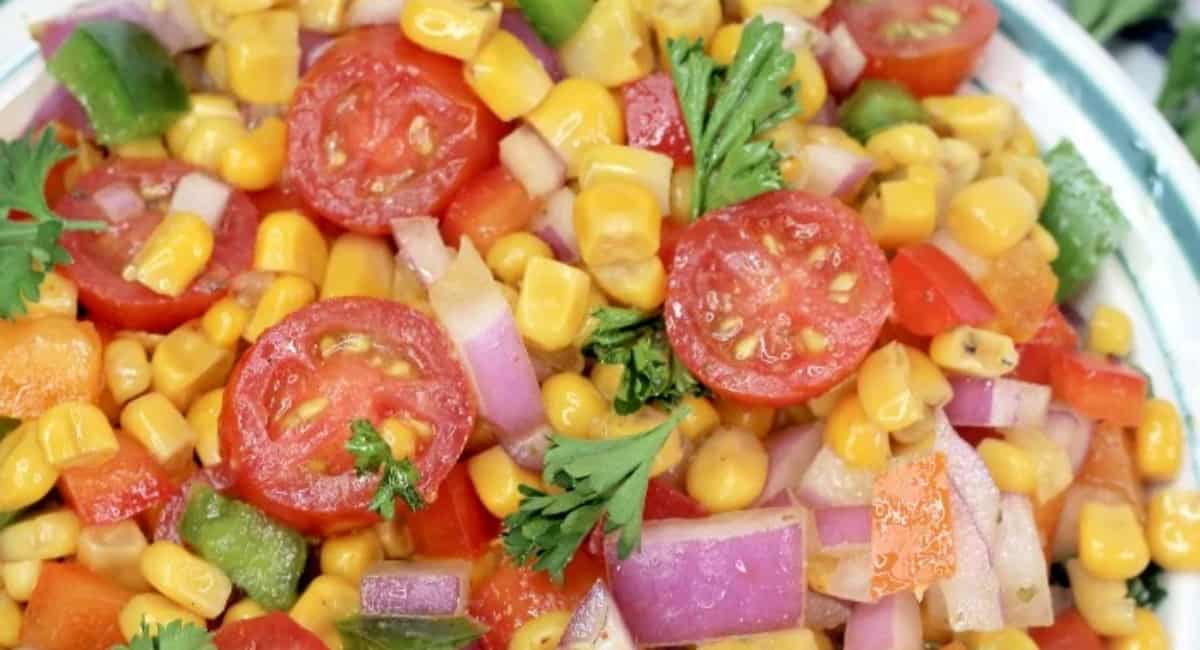 Cajun corn salad in a white bowl.