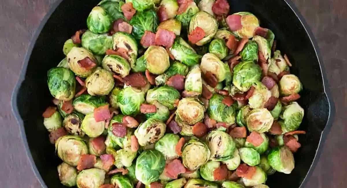 Brussel sprouts with bacon in a cast iron pan.