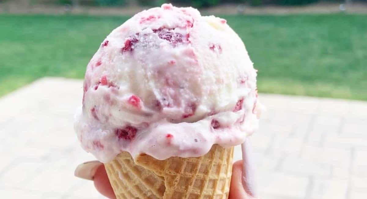 Raspberry ice cream in a waffle cone.