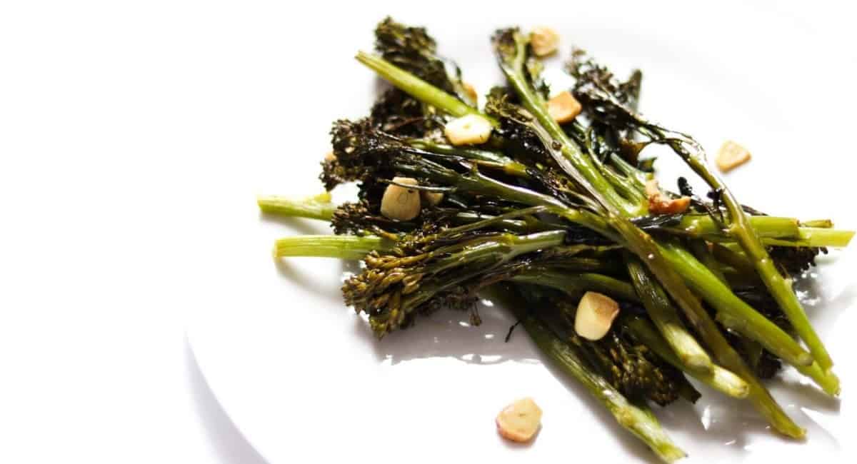 Tenderstem broccoli served on a white plate.