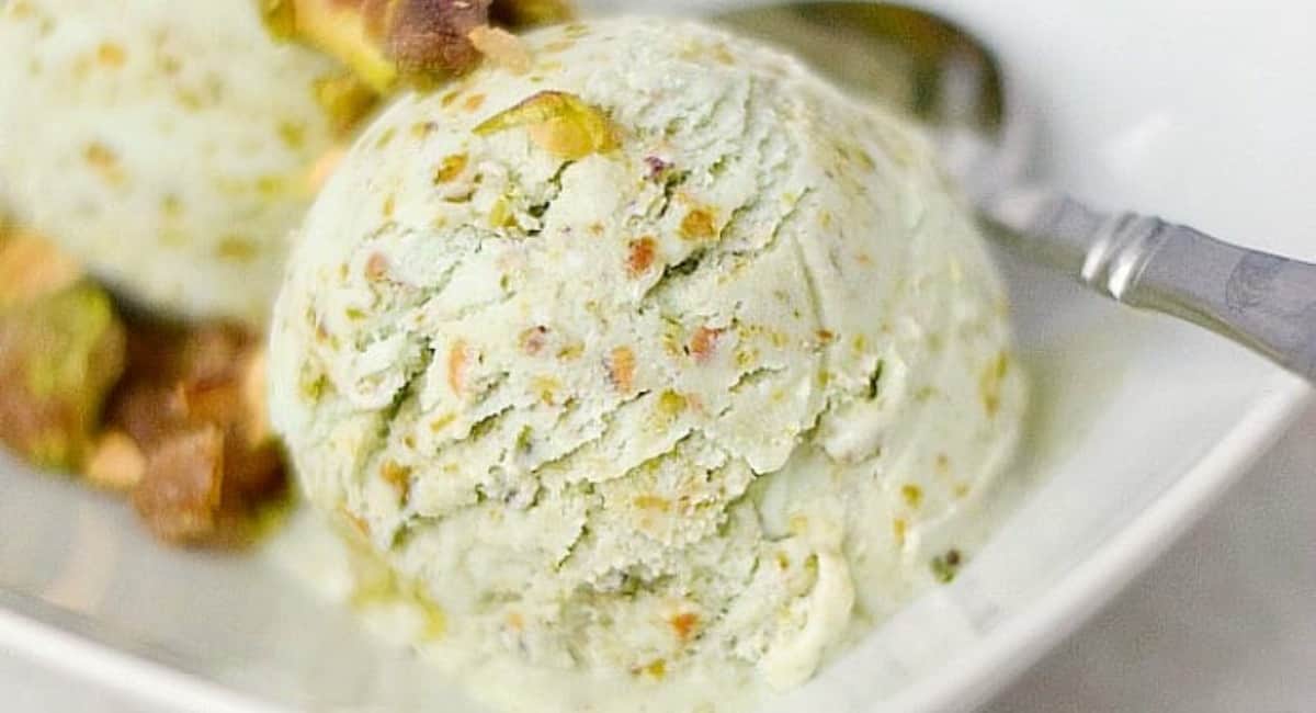 Pistachio ice cream served in a white bowl.