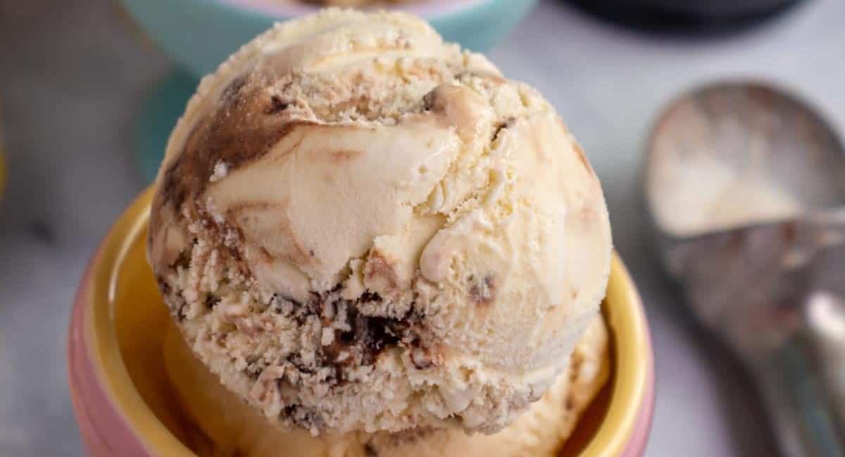 Tiramisu ice cream in a yellow ice cream cup.