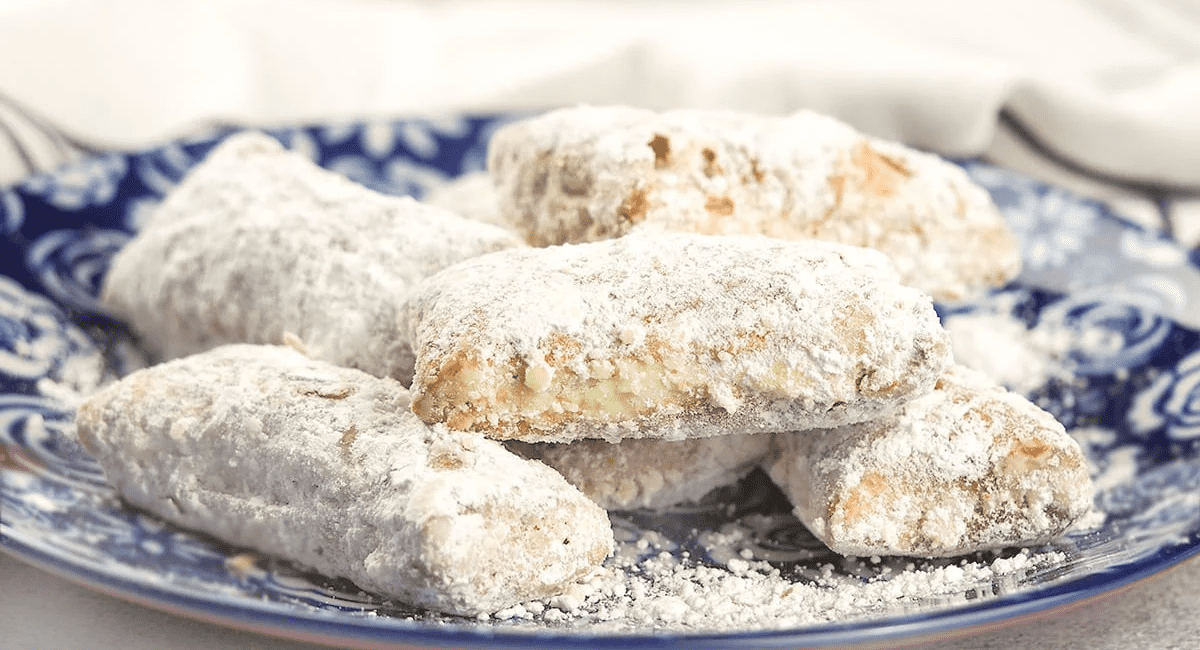 Homemade beignets fresh out of the instant pot air fryer and served on a blue plate.