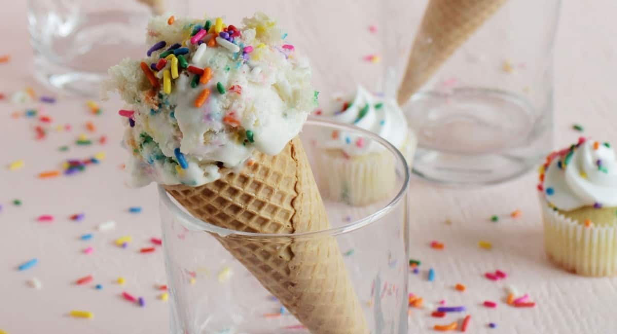 Birthday cake ice cream in a cone.