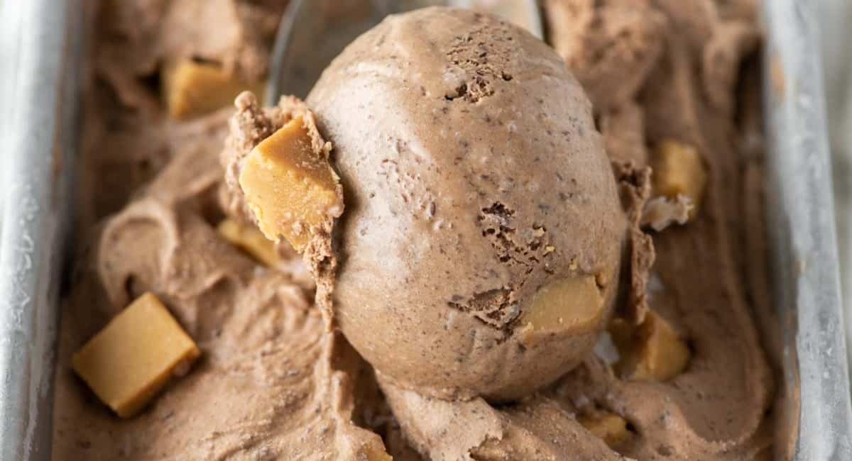 Scoop of chocolate peanut butter ice cream in metal scoop.