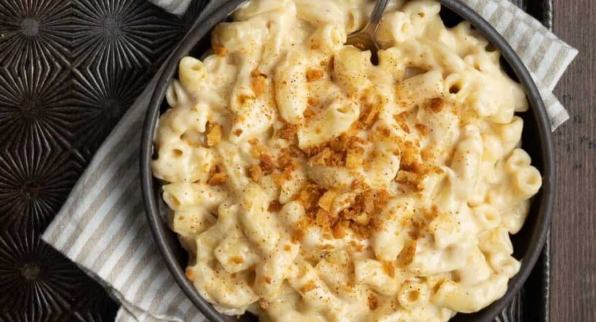 Mac and cheese in a dutch oven and topped with bread crumbs.