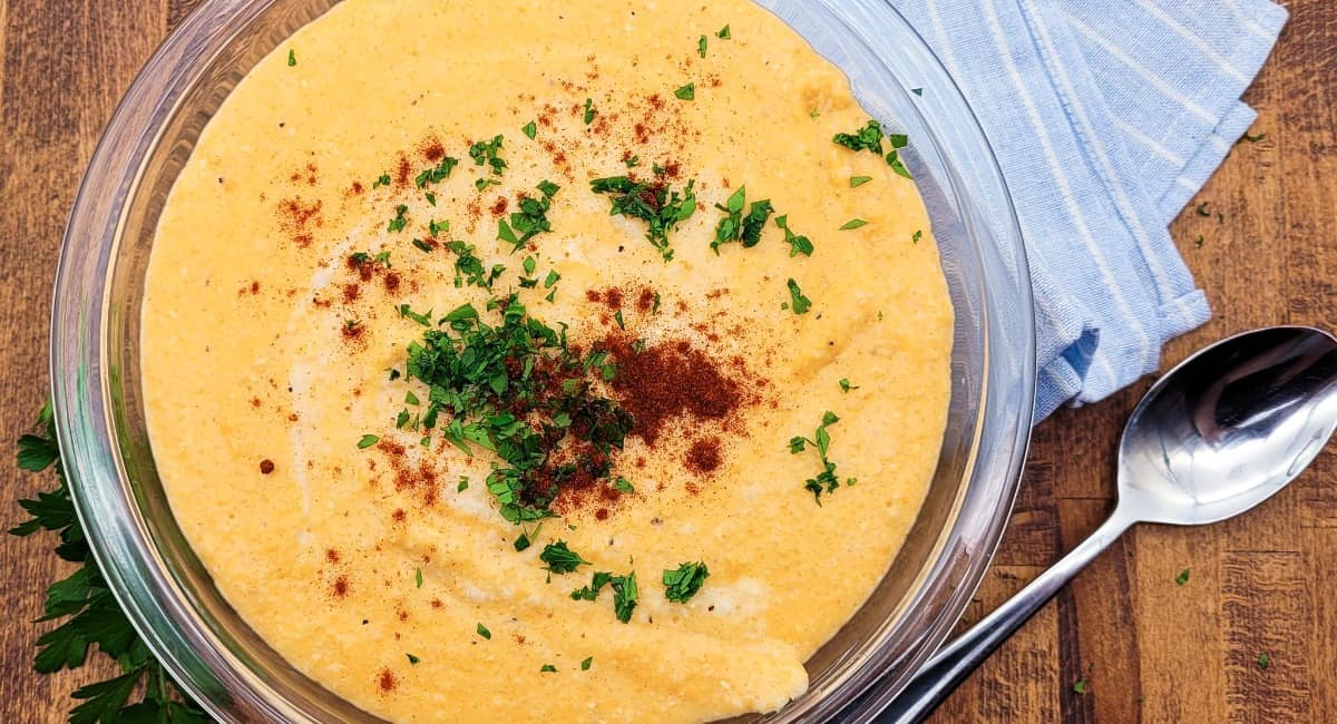 Cheesy grits in a clear bowl.