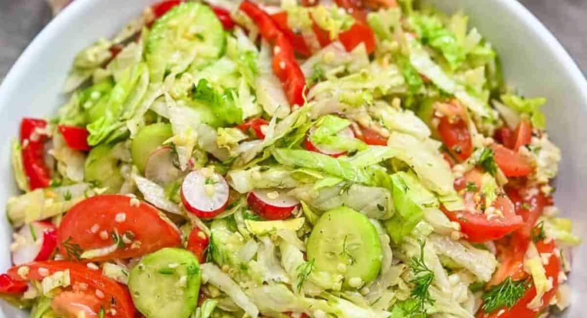 Iceberg lettuce salad in a white bowl.