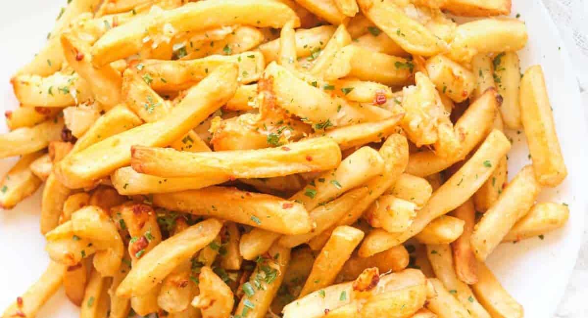 Garlic parmesan fries on a white plate.