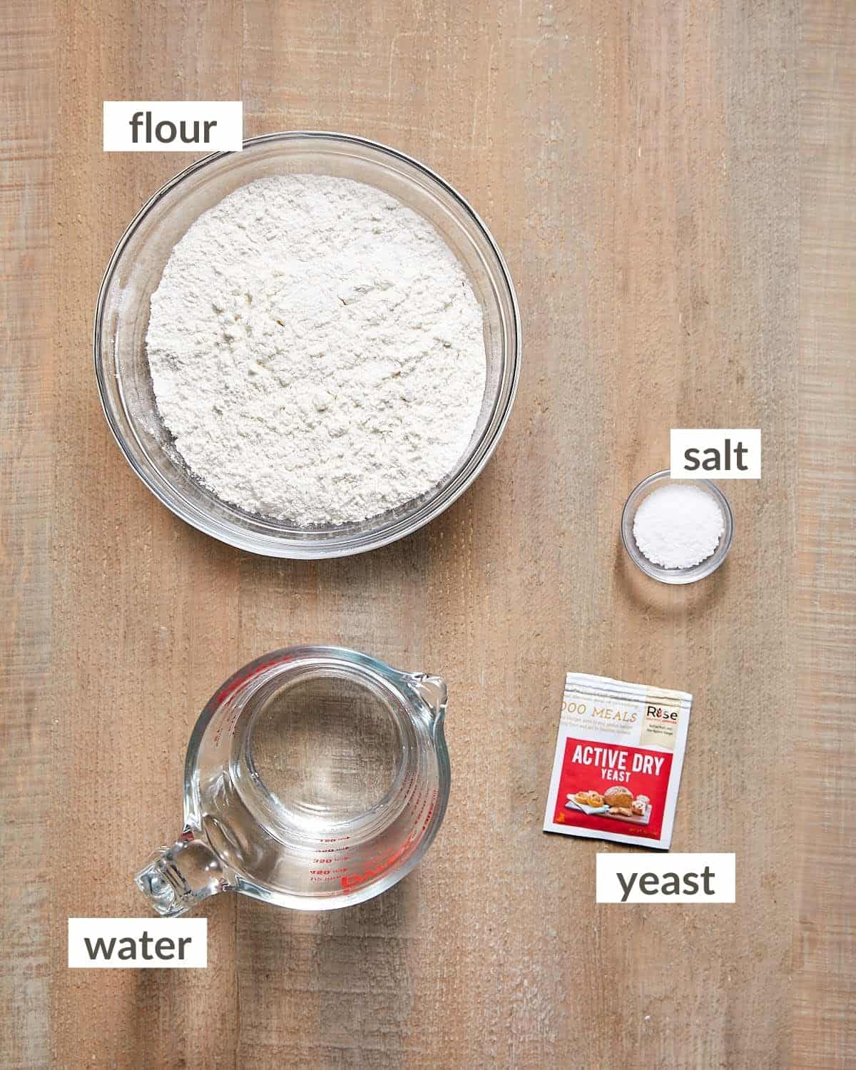 Ingredients needed to make rustic bread in glass bowls. 
