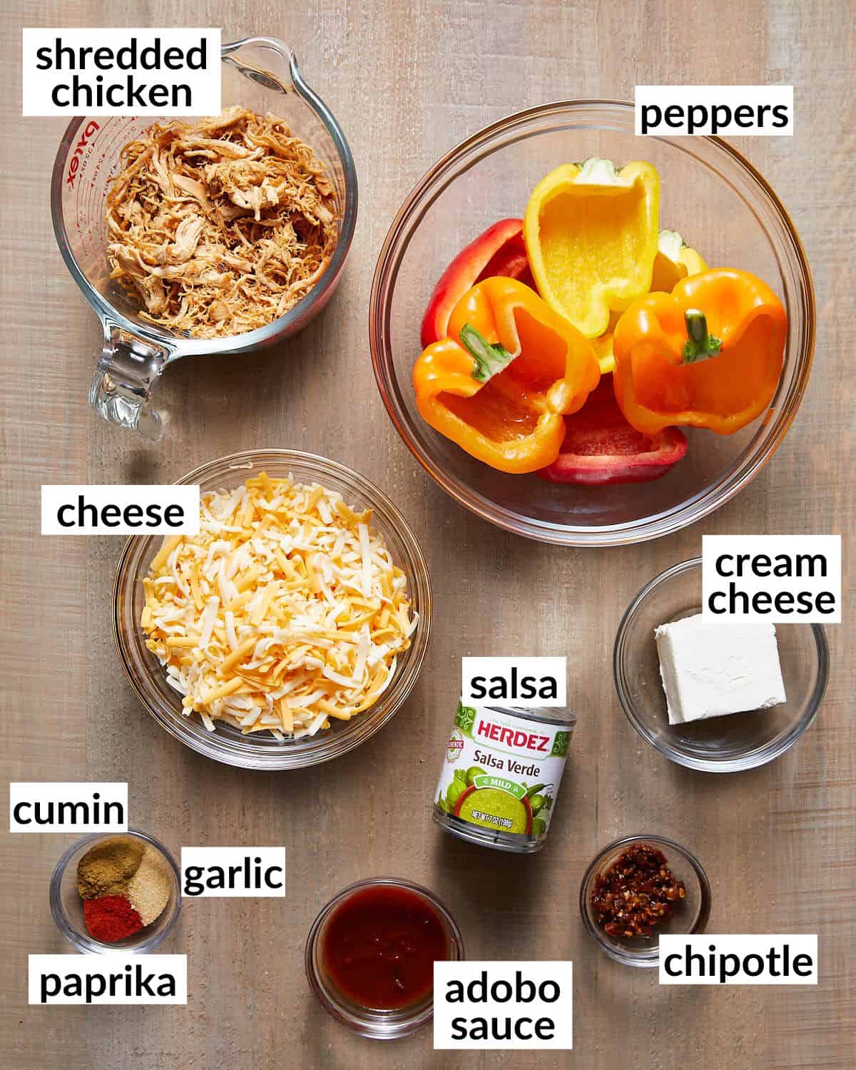 Ingredients needed to make chicken stuffed peppers in glass bowls. 