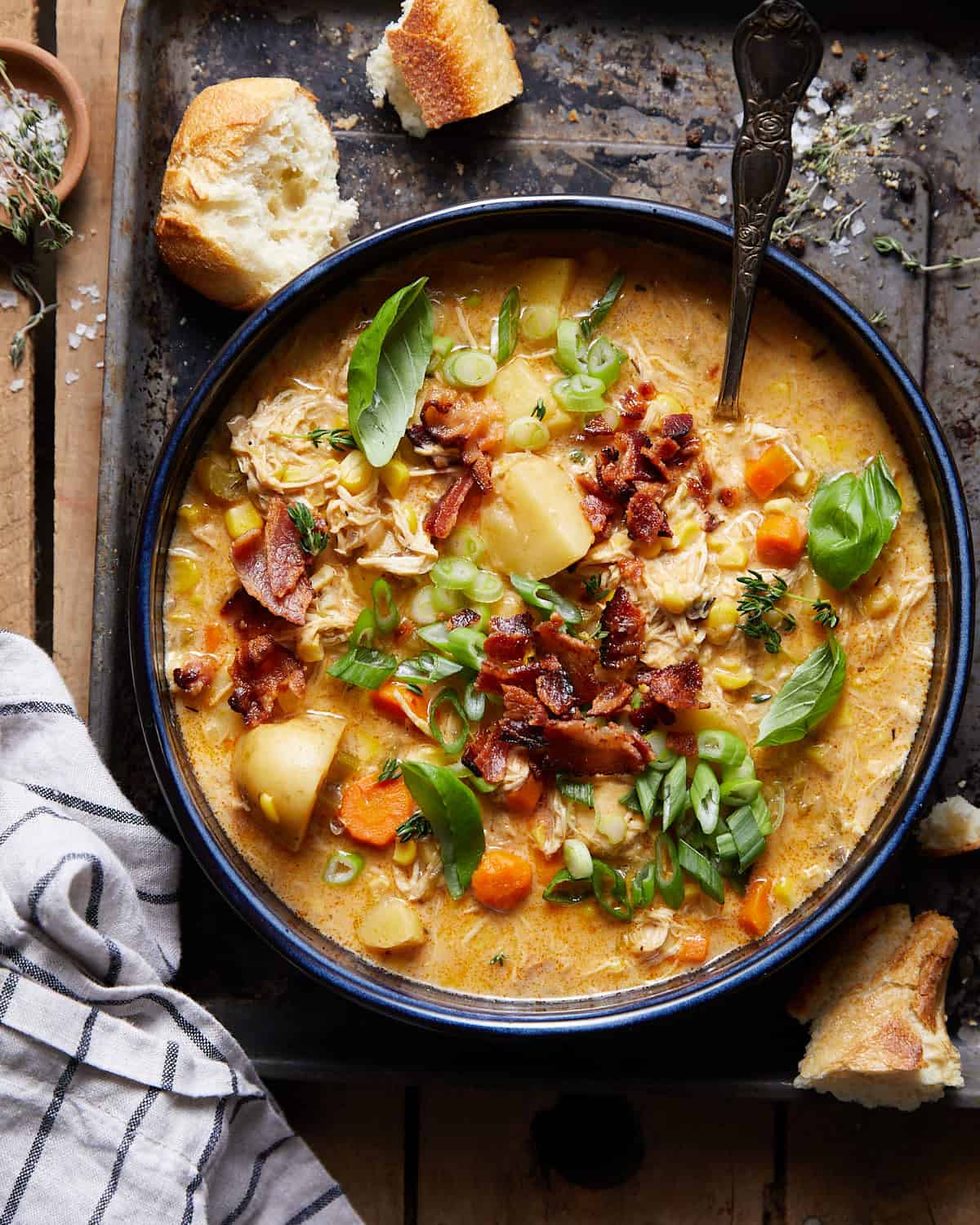 Photo of slow cooker creamy chicken and corn soup in a blue bowl.