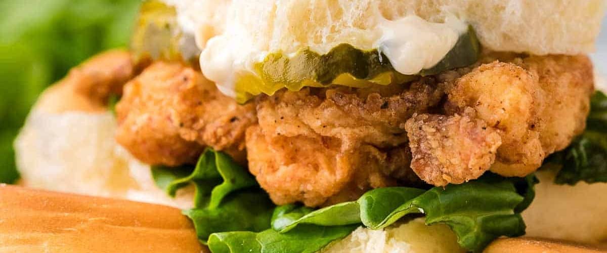 Fried chicken sliders with lettuce and pickles.