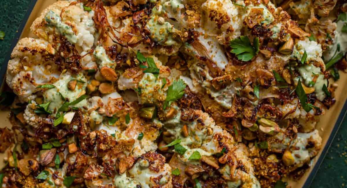 Overhead image of cauliflower steaks with caramelized shallots.
