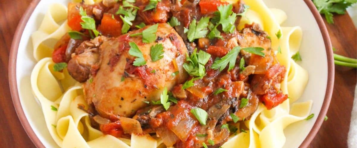 Slow cooker chicken cacciatore with garnish.