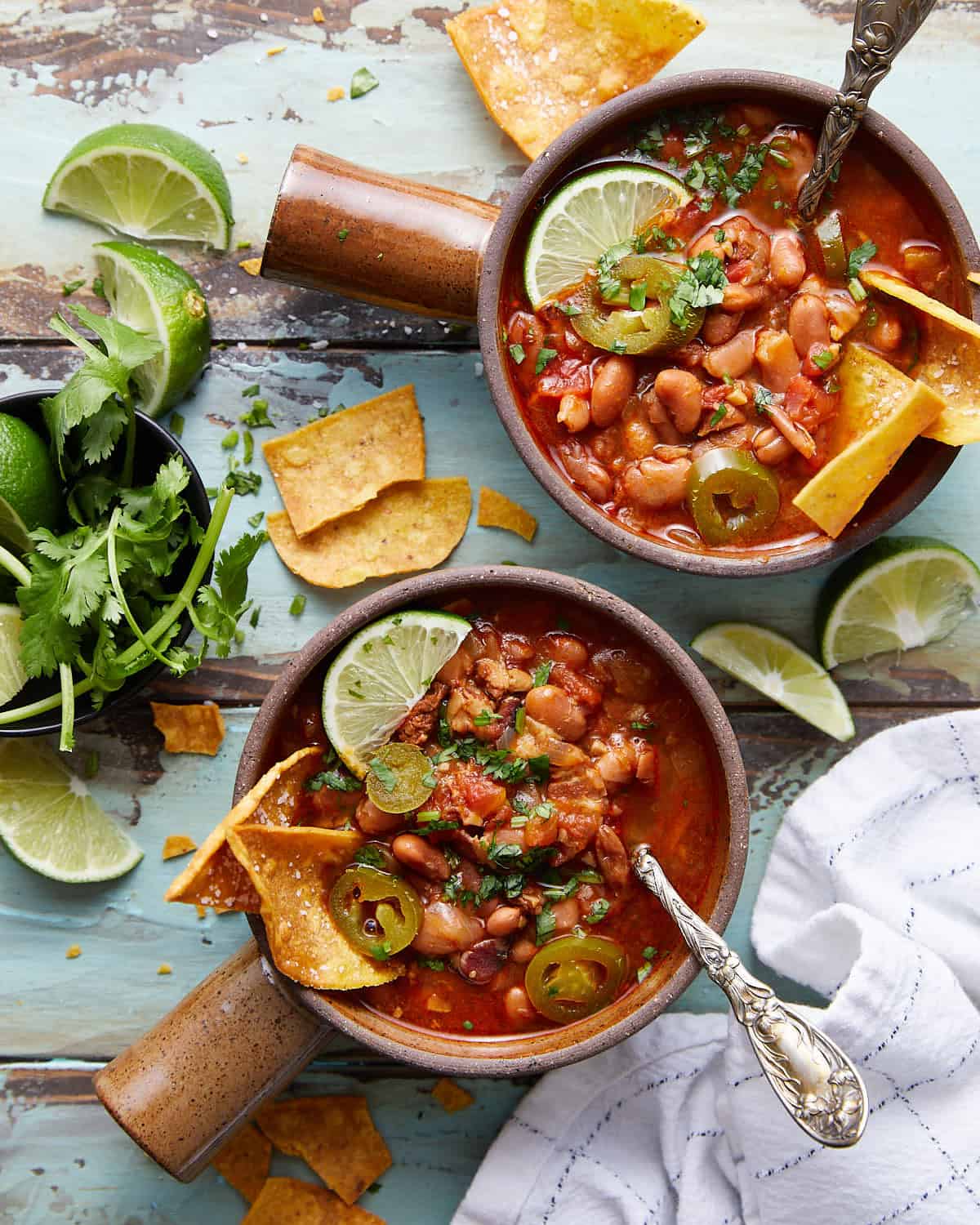 Overhead photo of instant pot charrot beans in two bowls with garnish.