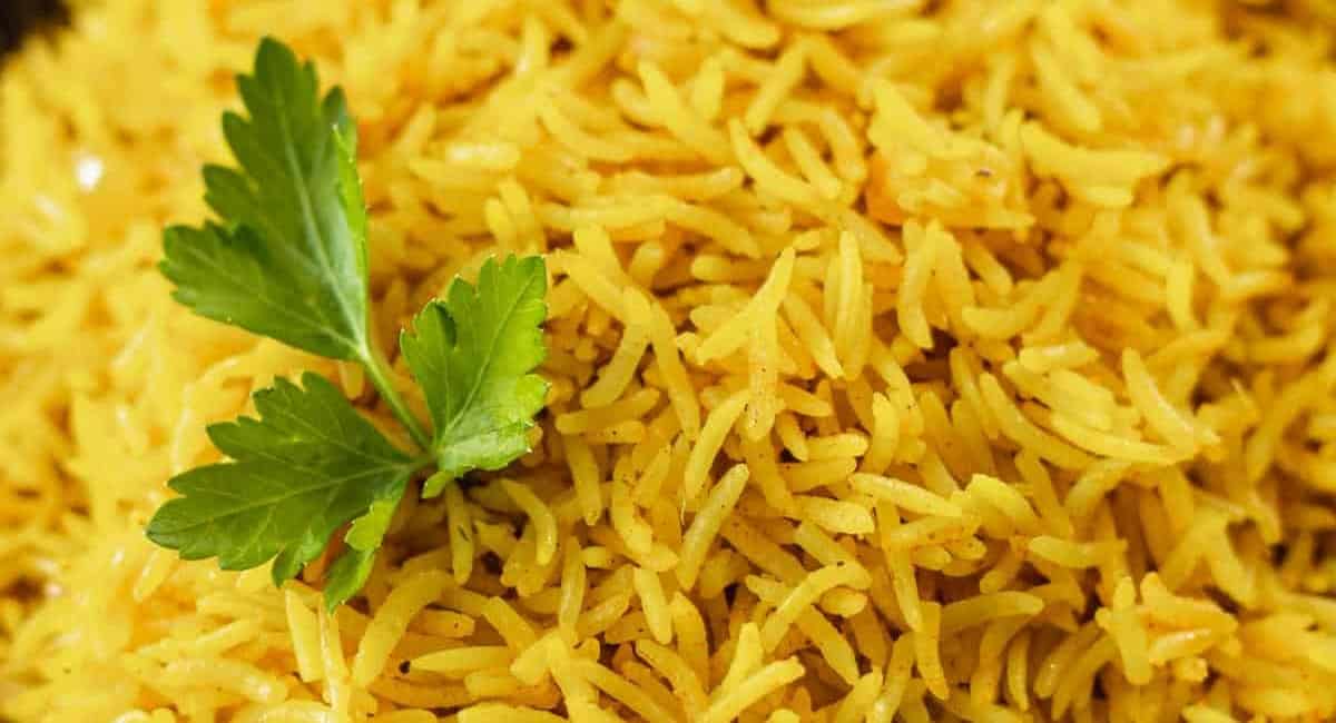 Up close image of instant pot yellow rice with garnish.