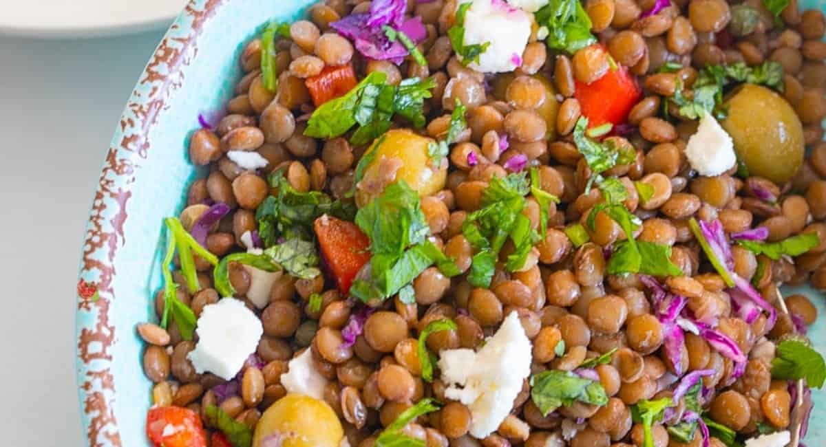 Overhead image of lentil salad in blue bowl.