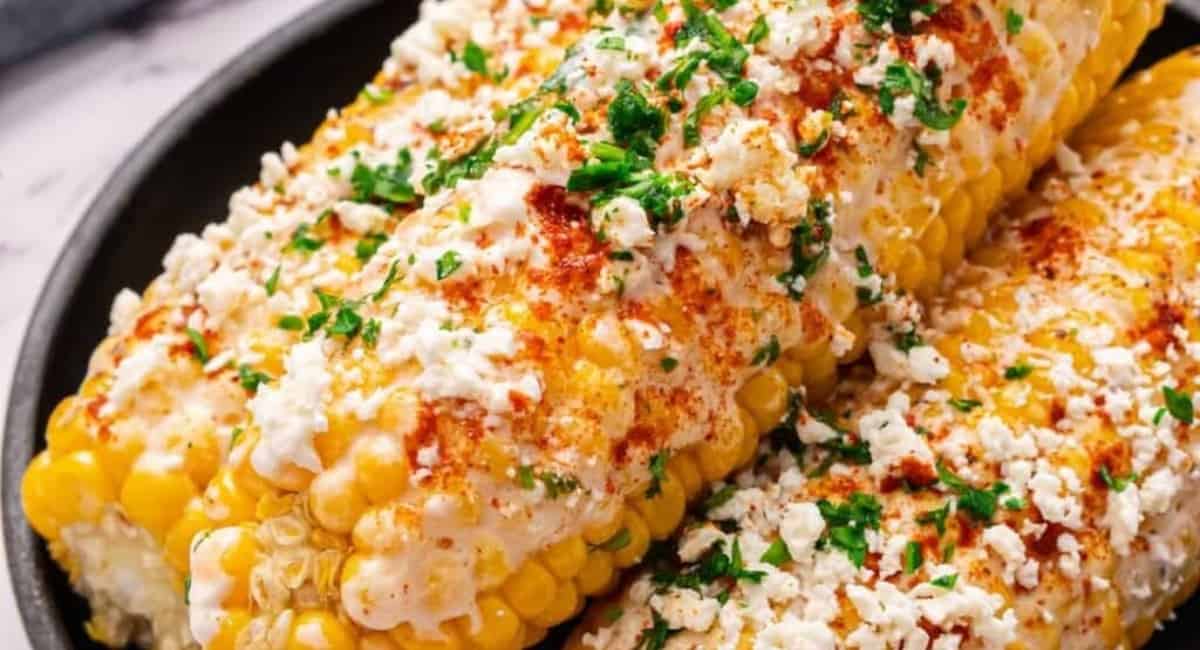 Up close image of elote with garnish.