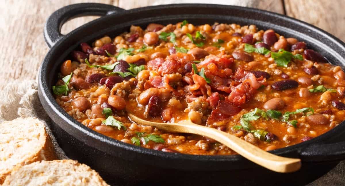 Overhead image of charro beans in black dish.