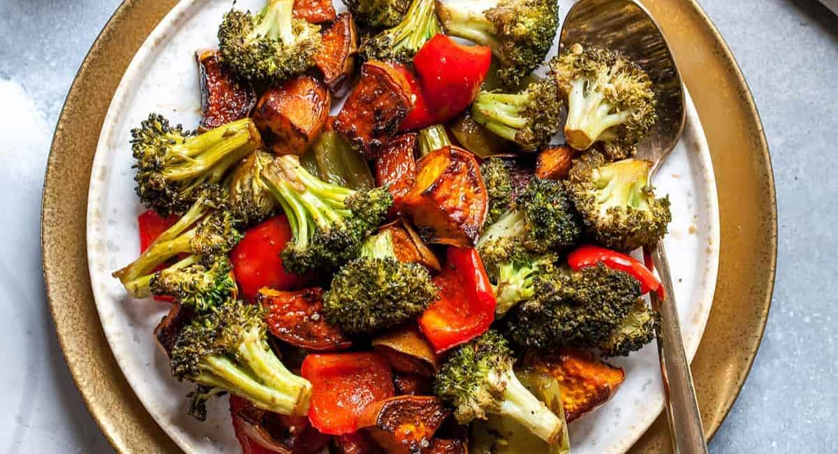 Overhead image of balsamic roasted vegetables on white dish.