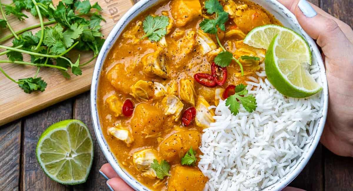 Overhead image of pumpkin chicken curry with coconut milk.