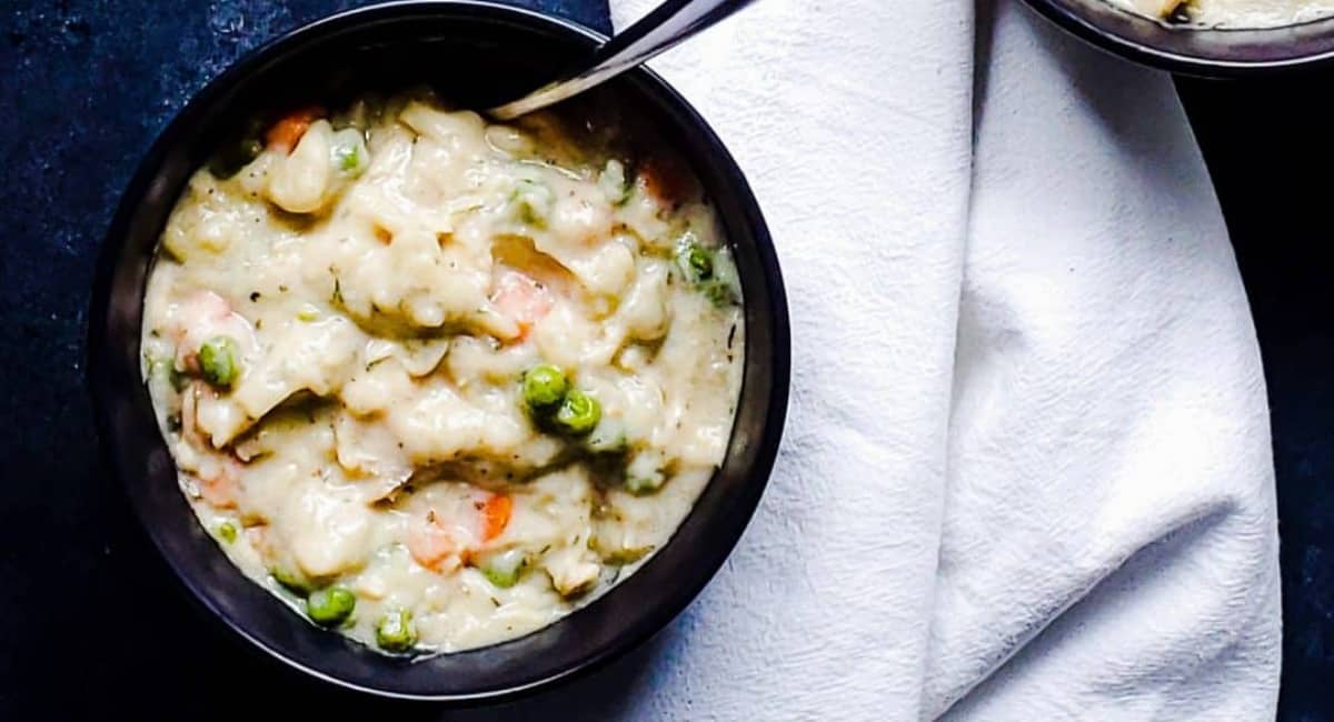 Overhead image of crockpot chicken and dumplings with biscuits.