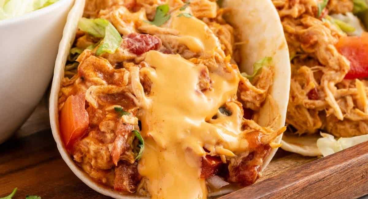 Up close image of slow cooker queso chicken tacos.