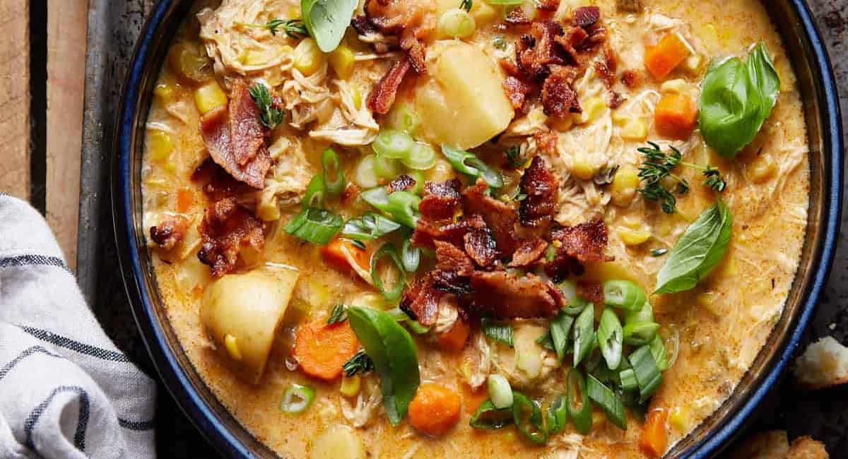 Overhead image of slow cooker creamy chicken and corn soup.