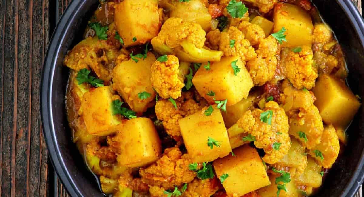 Overhead image of aloo gobi in black dish.