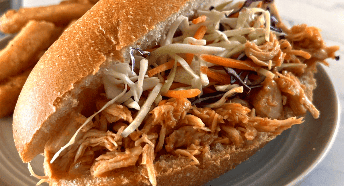 Up close image of slow cooker honey sriracha chicken.