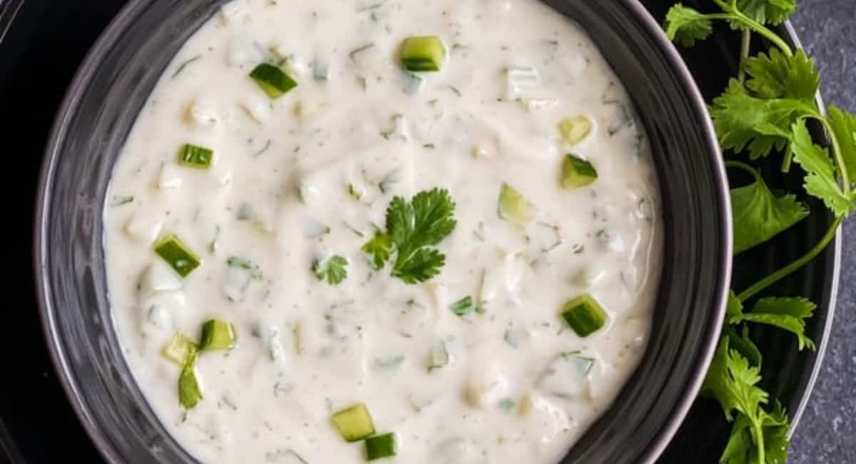 Overhead image of cucumber raita with garnish.