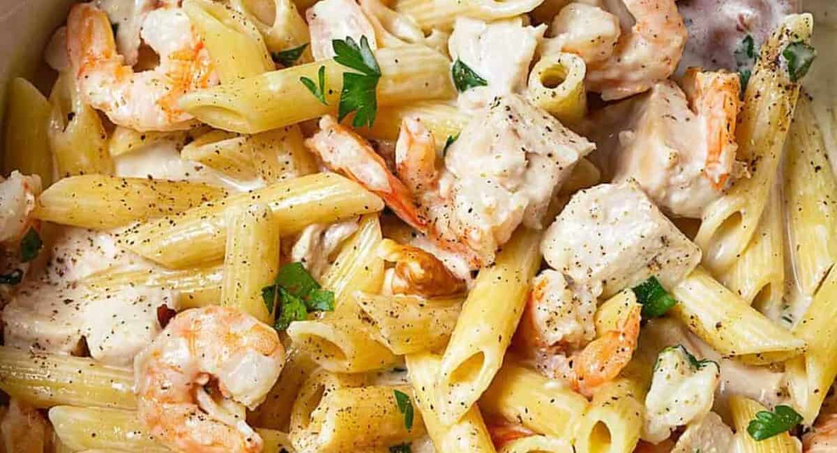 Up close image of chicken and shrimp pasta alfredo.