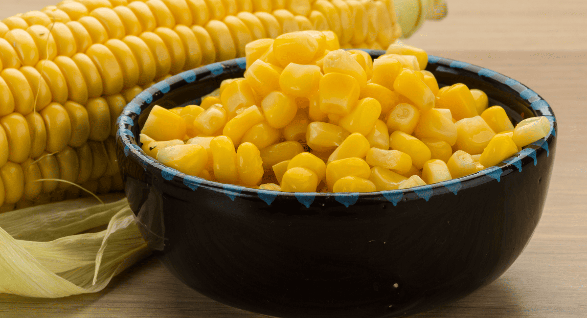 Up close image of corn kernels in black bowl.