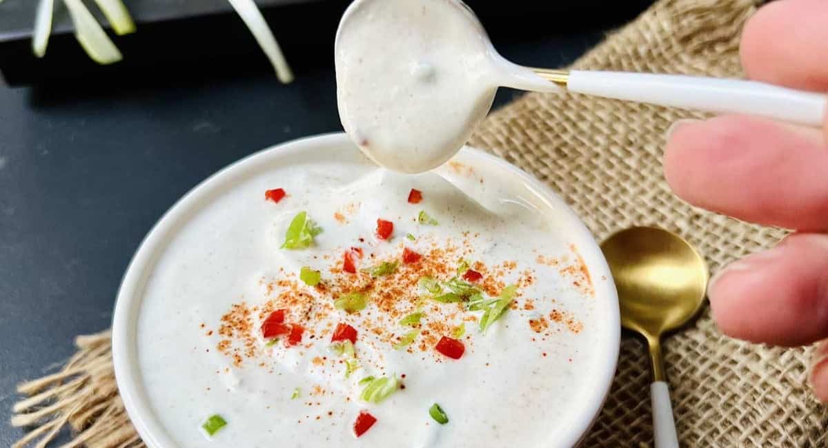 Up close image of sour cream sauce with garnish.