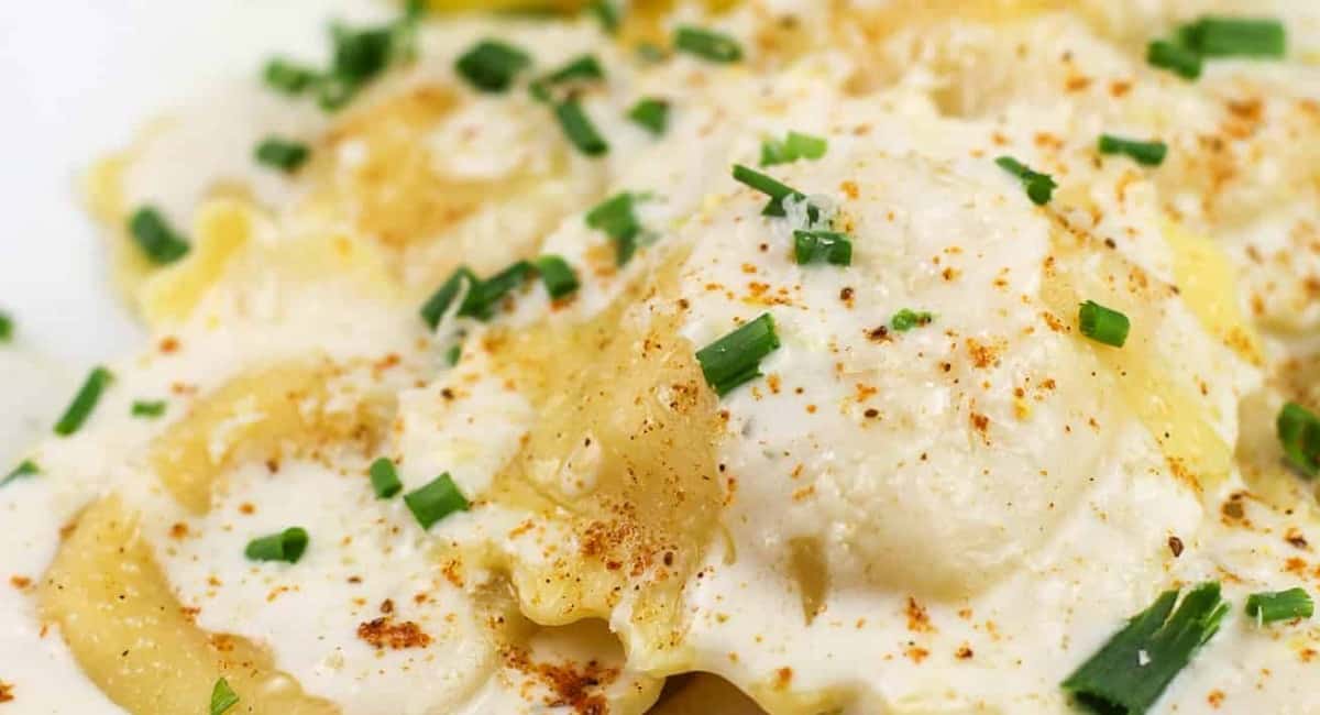 Up close image of lemon garlic cream sauce for lobster ravioli.