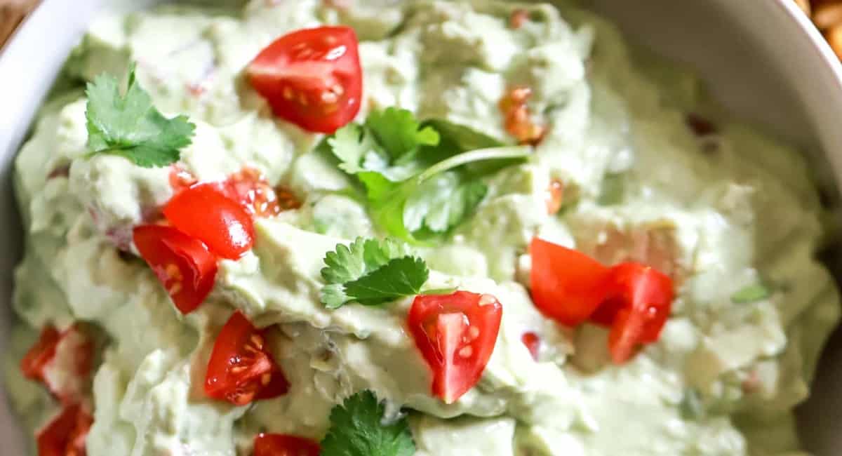 Up close image of sour cream lime guacamole. 