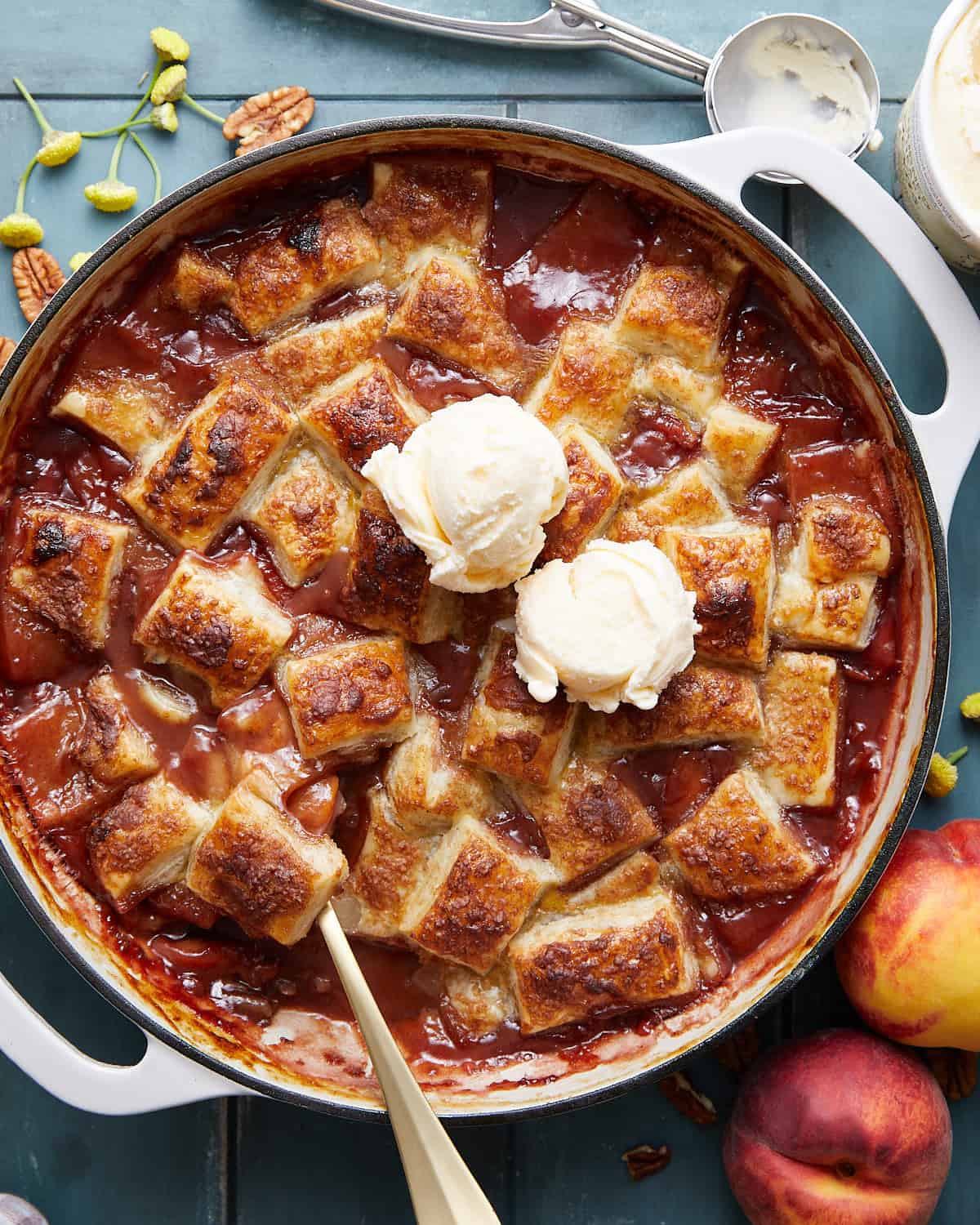 Overhead image of peach cobbler with puff pastry.