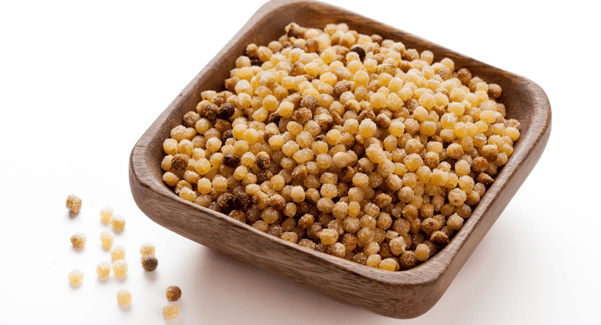 Image of fregola in brown bowl.