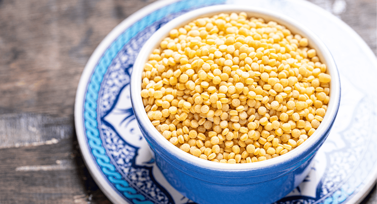 Overhead image of israeli couscous in blue bowl.