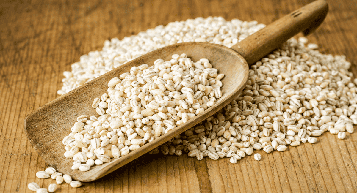 Image of pearl barley in wooden scoop.