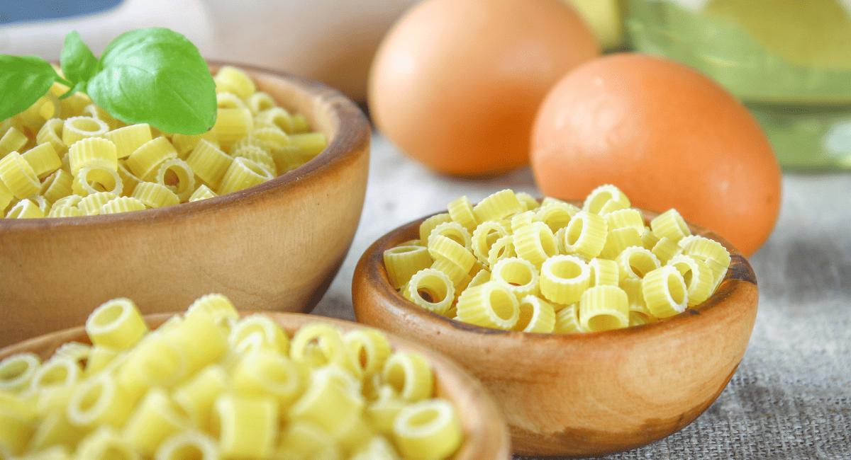 Up close image of tubettini pasta in brown bowls.