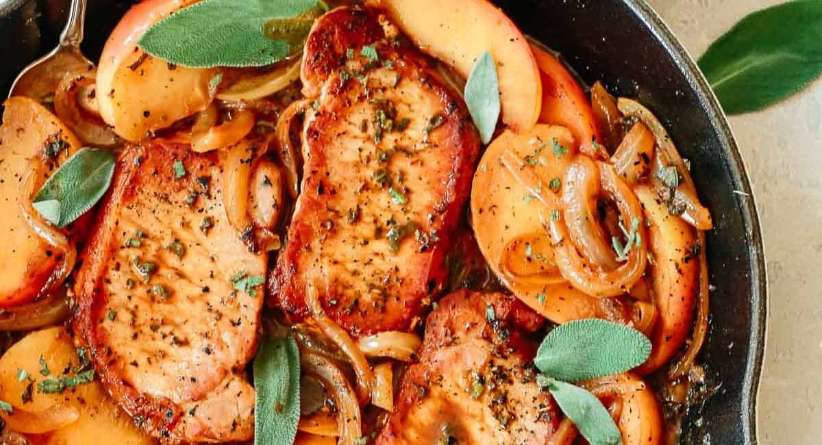 Overhead image of pork chops with apples and onions.