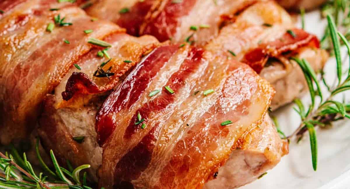 Up close image of bacon wrapped pork chops.