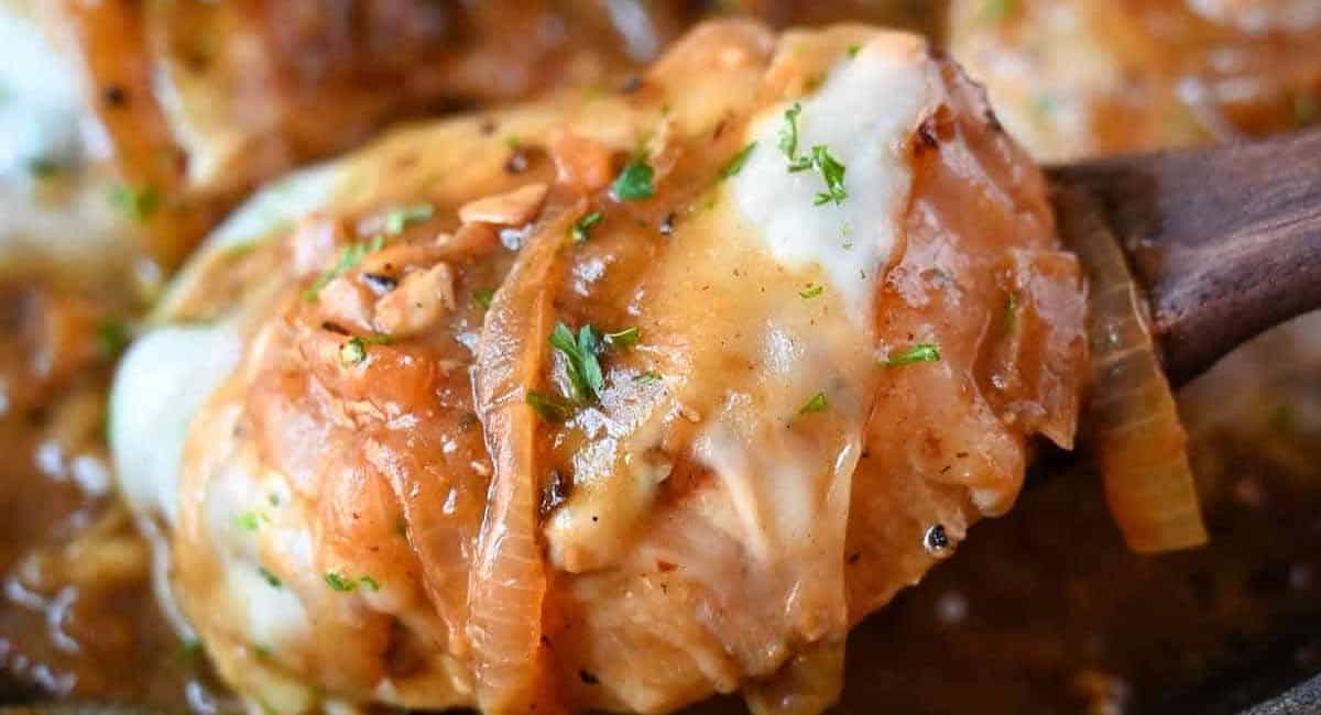 Up close image of french onion pork chop with garnish.